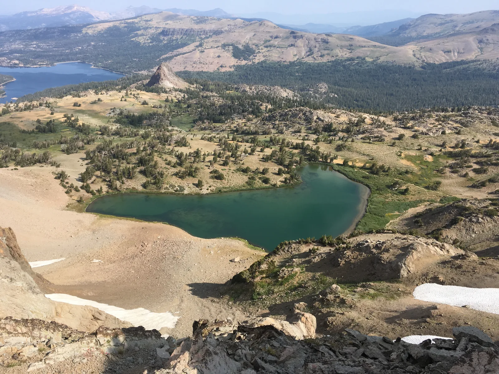 Still alpine lake beneath a broad mountain ridge